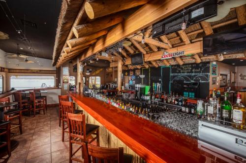 a bar in a restaurant with wooden walls and chairs at The Nautical Beachfront Resort in Lake Havasu City