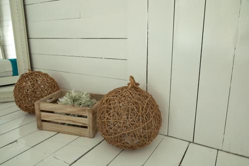 a porch with two large balls and a wooden box at Zensus Eco Boutique Hotel in Bacalar