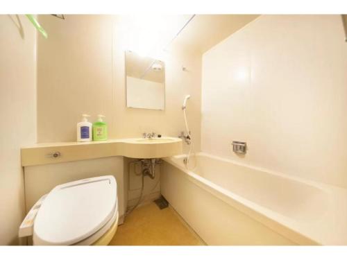 a bathroom with a toilet and a sink and a tub at Fujinomiya Green Hotel - Vacation STAY 19011v in Fujinomiya