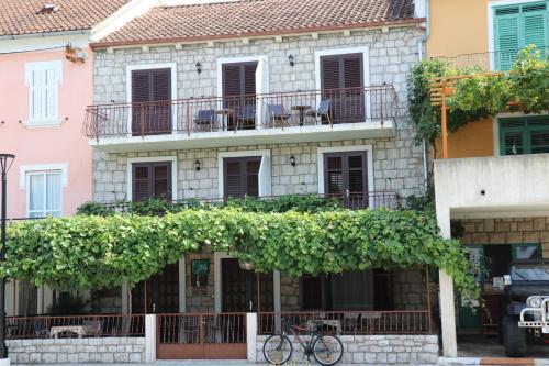 a building with a bike parked in front of it at APARTMANI JURIĆ in Trpanj