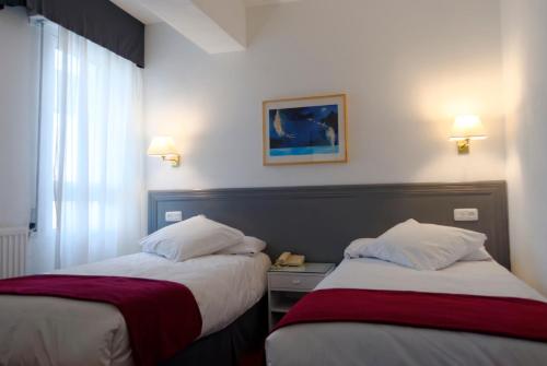 Säng eller sängar i ett rum på Hotel Vigo Plaza