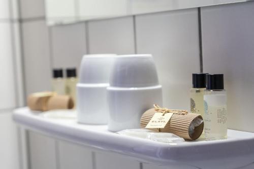 a shelf with toiletries on it in a bathroom at Hotel & Apartments Böhm in Gravenwerth