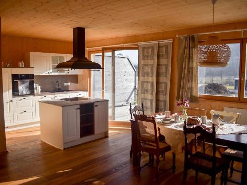 a kitchen with a table and a dining room at Ferienhaus mit Charme in Attersee am Attersee