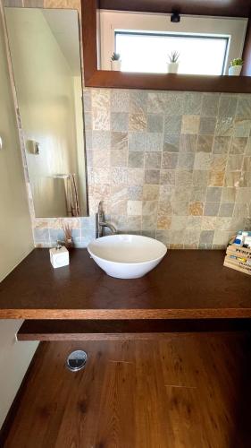 a bathroom with a white sink and a mirror at Herdade do Gizo - Casa Reis in Cuba