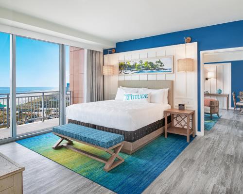 a hotel room with a bed and a balcony at Margaritaville Jacksonville Beach in Jacksonville Beach