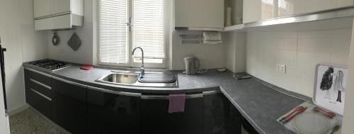 a kitchen with a sink and a counter top at Appartamento Via Rieti in Senigallia