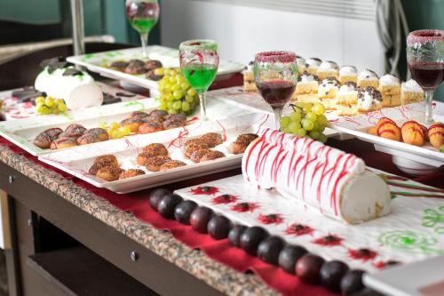 a table topped with different types of food and glasses of wine at Temple Miletos Spa Hotel in Didim