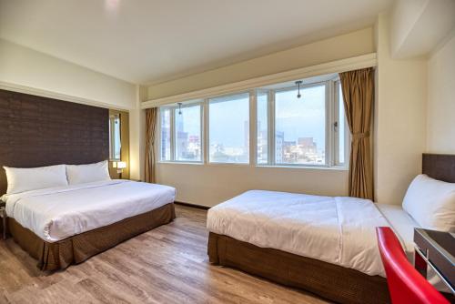 a hotel room with two beds and a window at Jih Lih Hotel in Magong