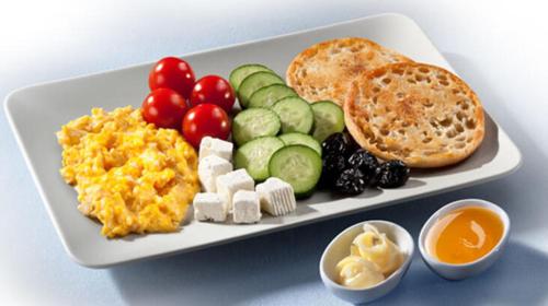 a plate of breakfast food with eggs cheese and bread at Private Villa Room Near Airport in Arnavutköy