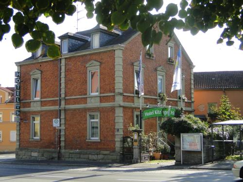 een bakstenen gebouw met een bord ervoor bij Hotel Kitzinger Hof an der B8 in Kitzingen