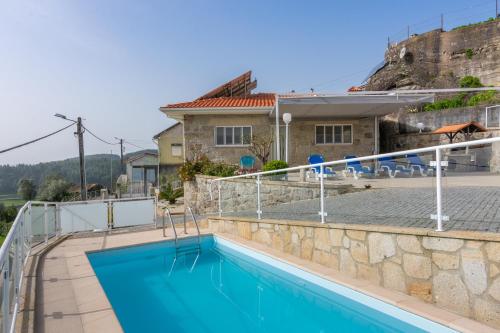 a villa with a swimming pool and a house at Casa do Alto do Vez in Balouta