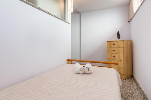 a bedroom with a bed with two towels on it at Aldeamento Casas do Alto do Vez in Balouta