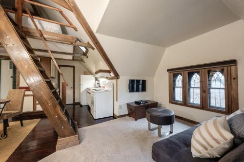 a living room with a staircase and a couch at Stone Soup Inn in Indianapolis