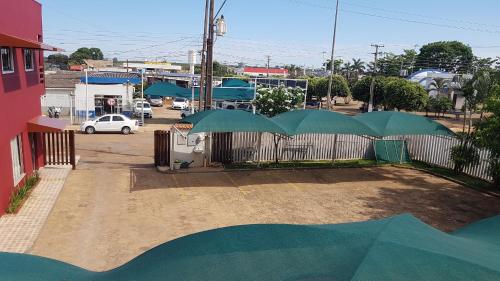 a group of green umbrellas on top of a fence at Hotel Comodoro in Comodoro