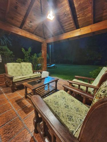 a patio with two chairs and a table at Nagual B&B - Airport Shuttle in Tristán Suárez