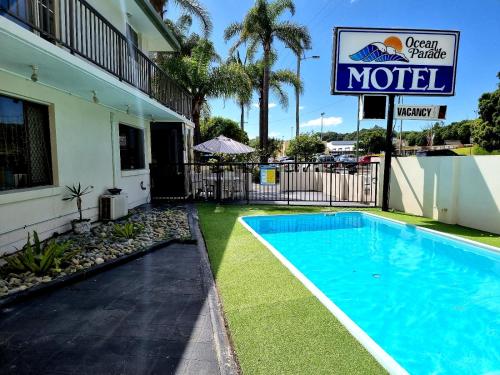 a swimming pool in front of a motel at Ocean Parade Motel in Coffs Harbour