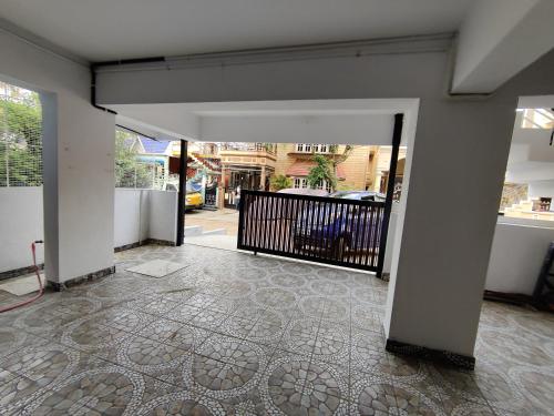 an empty hallway with a gate and a tile floor at Royal Wings Apartments in Mysore