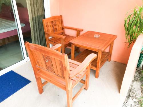 a table and two chairs and a table and a table and a table and chairs at Discovery House Hotel SHA Plus in Nai Yang Beach