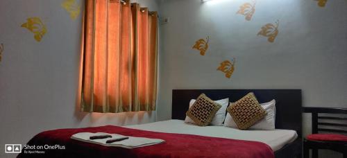 a bedroom with a bed with shoes on it at The Salvation Army RED SHIELD GUEST HOUSE in Kolkata