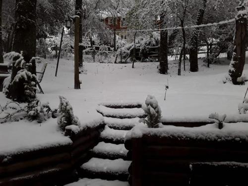 a snow covered stairway in a park at Cabaña Adolim in San Martín de los Andes