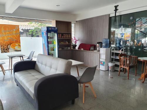 a store with a couch and tables and chairs at Neo Hotel in Khon Kaen