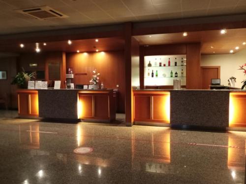 a lobby of a hotel with a bar in it at Hotel Monte Rio Aguieira in Almaça