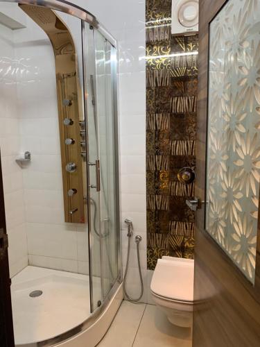 a bathroom with a shower and a toilet at Beverly villa in Ooty
