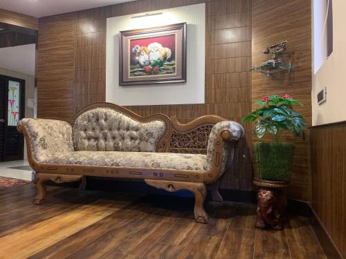 a couch in a room with a painting on the wall at Beverly villa in Ooty