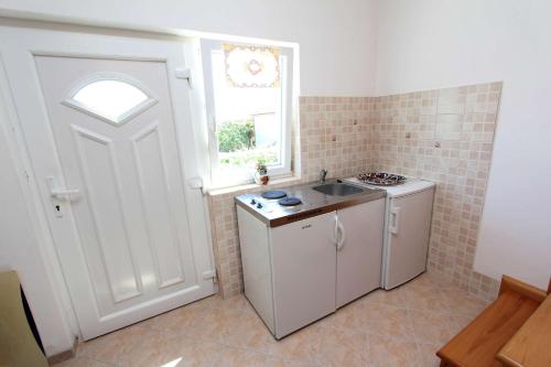 Il comprend une cuisine équipée d'un évier et d'un lave-linge. dans l'établissement Apartment Monika, à Rovinj