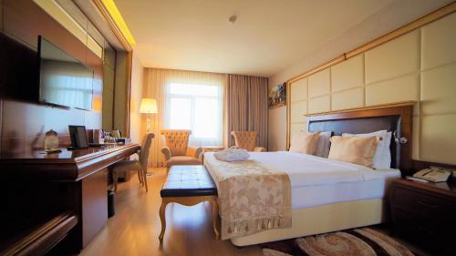 a hotel room with a bed and a desk at Wyndham Batumi in Batumi