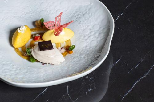 a white dessert in a white bowl on a table at Hotel Ristorante Eurossola in Domodossola
