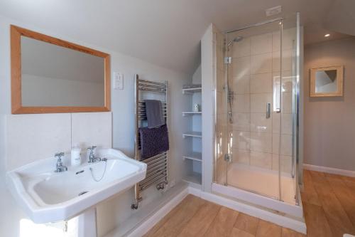 a bathroom with a sink and a shower at 6 Lakeside Avenue in Thorpeness