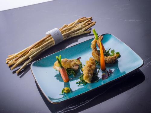 a plate of food with vegetables on a table at Hotel Ristorante Eurossola in Domodossola