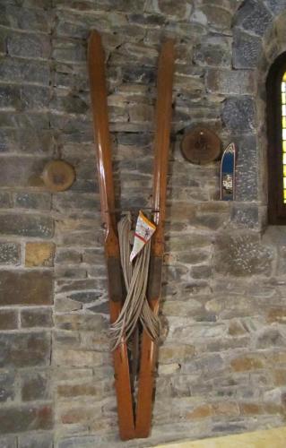 a pair of skis hanging on a stone wall at Hotel Sant Bernat in Montseny