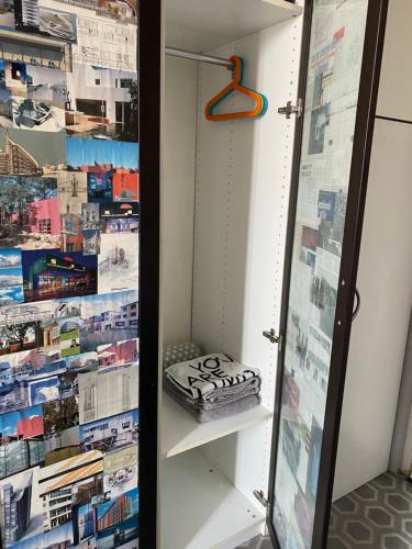 a closet with a book shelf at Stanza privata con bagno a 15 minuti da Duomo in Sesto San Giovanni
