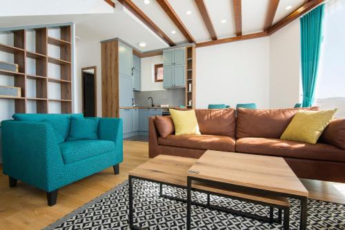 a living room with a couch and two chairs at Vila S6 in Zlatibor