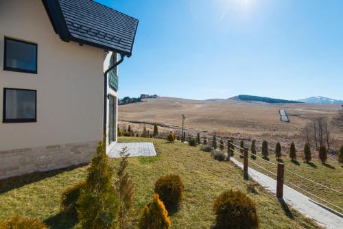 a house with a solar panel on the side of it at Vila S6 in Zlatibor