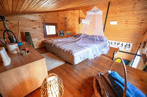 a bedroom with a bed in a log cabin at Sagando - Floating house on Sava river in Belgrade