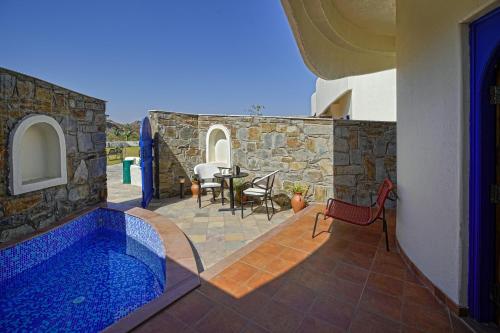 a house with a swimming pool and a table and chairs at Ramee Royal Resort & Spa - Udaipur in Udaipur