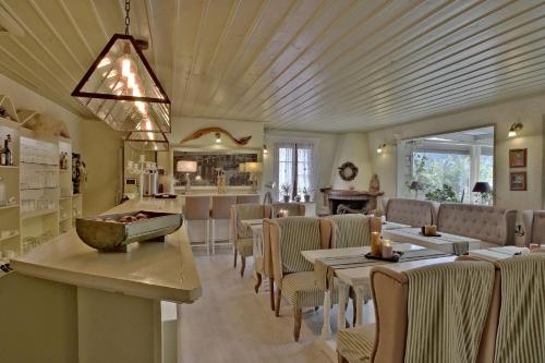 a restaurant with tables and chairs and a bar at Boutique Hotel Skamnos Arachova in Arachova