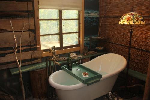 a bathroom with a bath tub and a window at GranGlam - Vacation STAY 24973v in Susaki