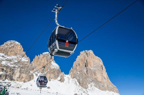 a ski lift in front of a mountain at Hotel Bellevue in Canazei