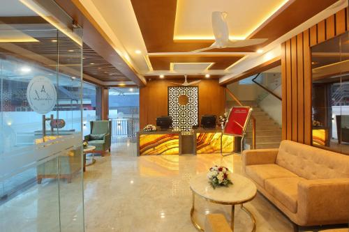 a lobby with a couch and a table at HOTEL AMALA in Pathanāmthitta