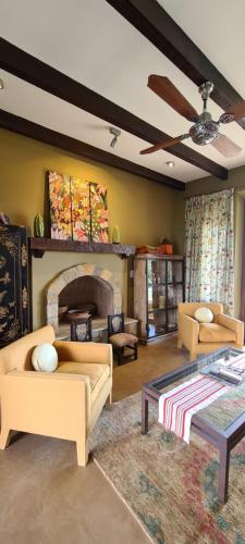 a living room with two couches and a fireplace at Casa Tannat by Cafayate Holiday in Cafayate