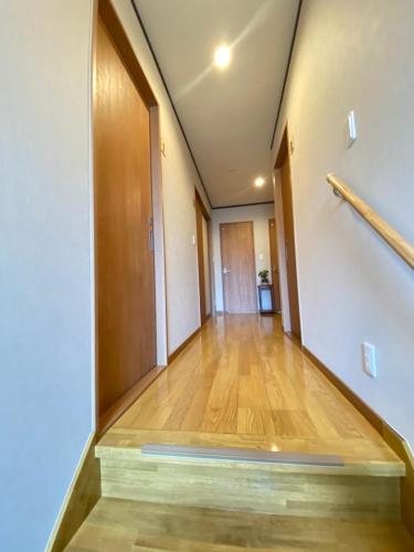 an empty hallway with a wooden floor in a building at LINK HOUSE in Fujiyoshida