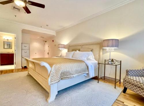 a bedroom with a large bed and a couch at Inn on Main Hotel in Manasquan