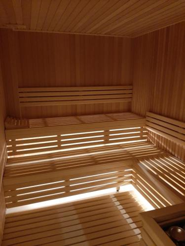an empty sauna with light shining on the inside at Apartman DiamondLux Vrnjacka Banja in Vrnjačka Banja