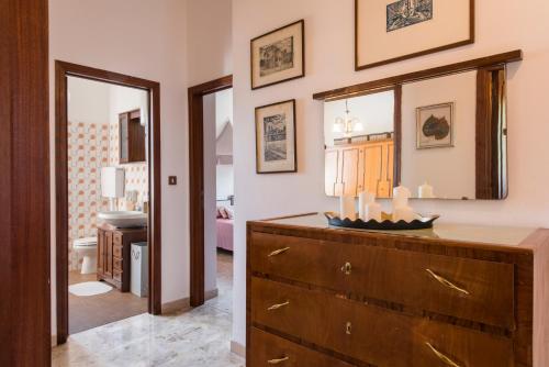 a living room with a dresser and a bedroom at Il Rifugio di Amelia in Arezzo