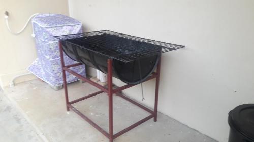 a table with a grill on it next to a wall at LMS homestay in Alor Setar