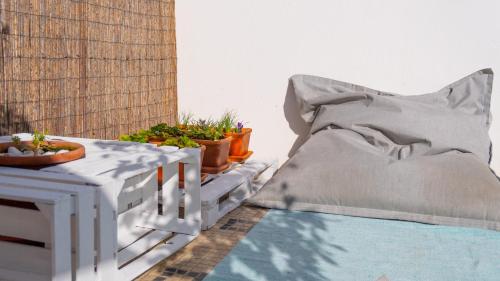 a bed sitting on top of a balcony with plants at Perfect Shore Guest House in Baleal